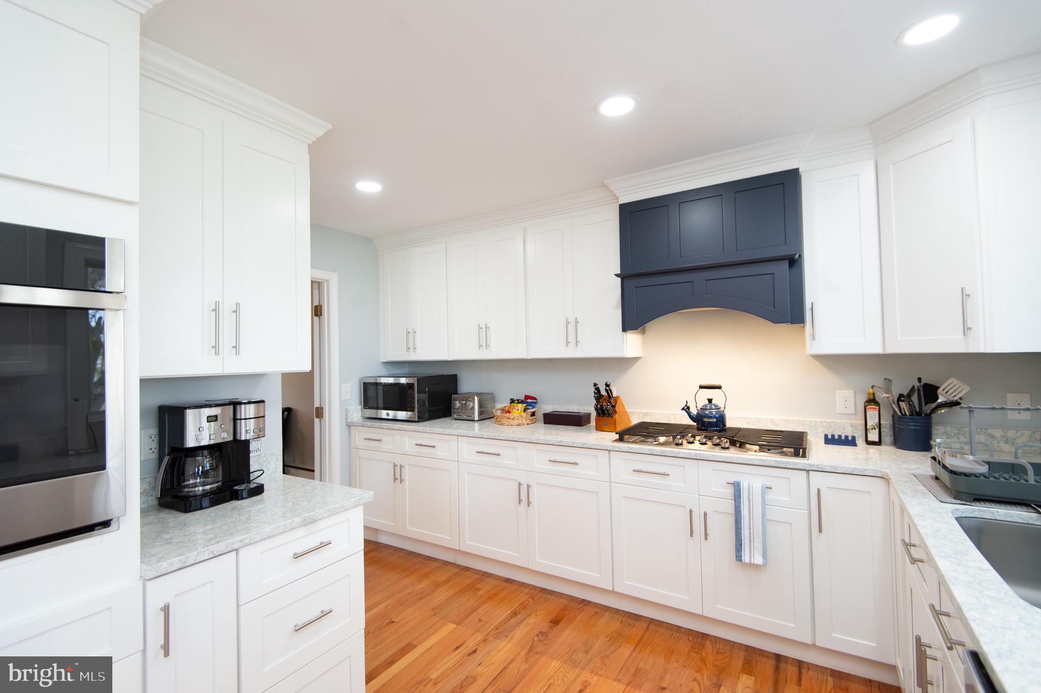 1417 School Street Cambridge, MD 21613 - Photo 28 of 73 a kitchen with a sink a stove and cabinets
