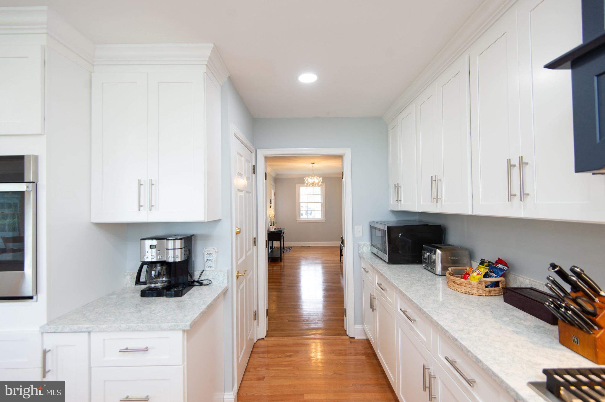 1417 School Street Cambridge, MD 21613 - Photo 29 of 73 a kitchen with granite countertop a sink a stove and cabinets