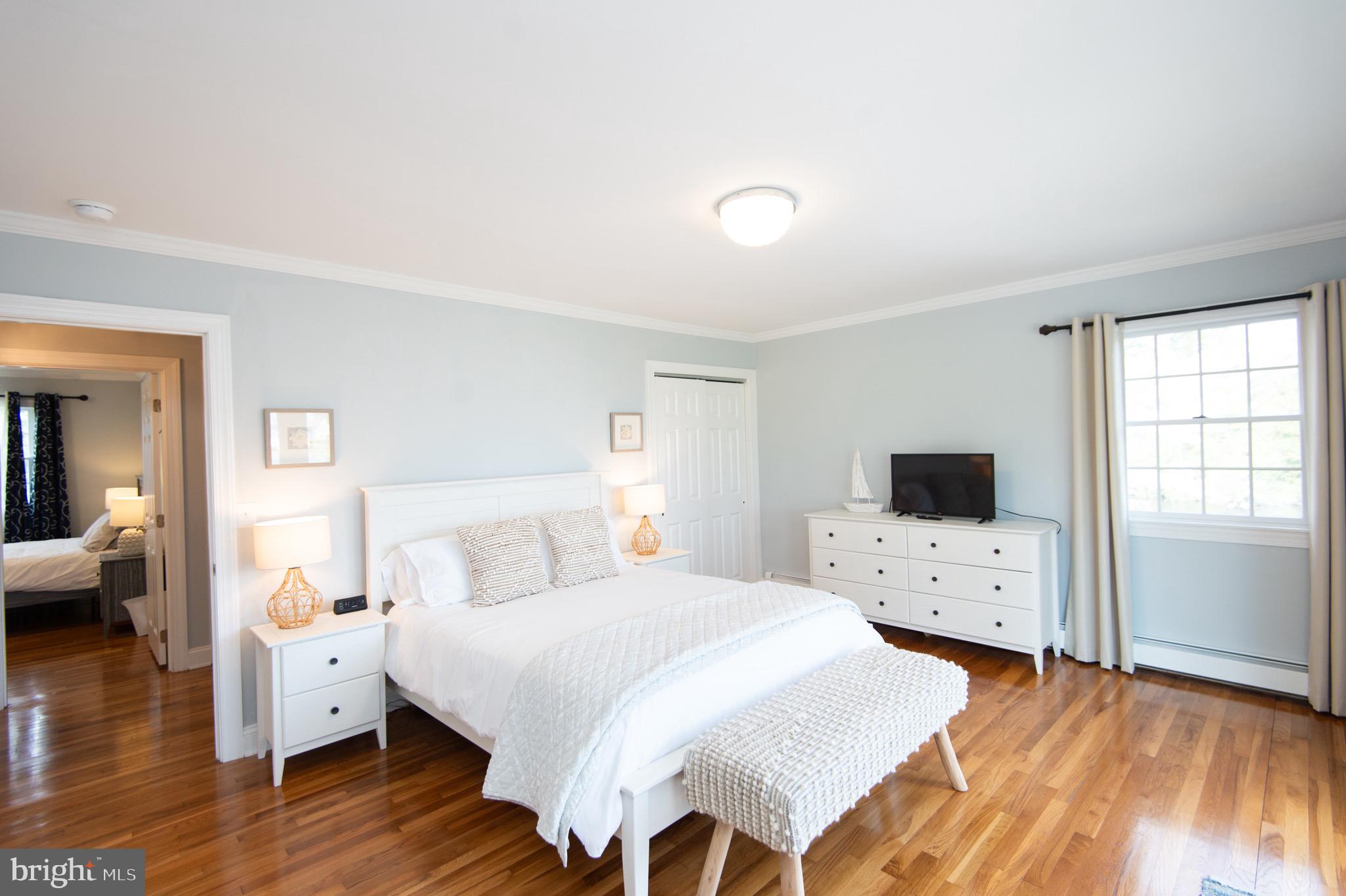 1417 School Street Cambridge, MD 21613 - Photo 34 of 73 a bedroom with a bed and a flat screen tv