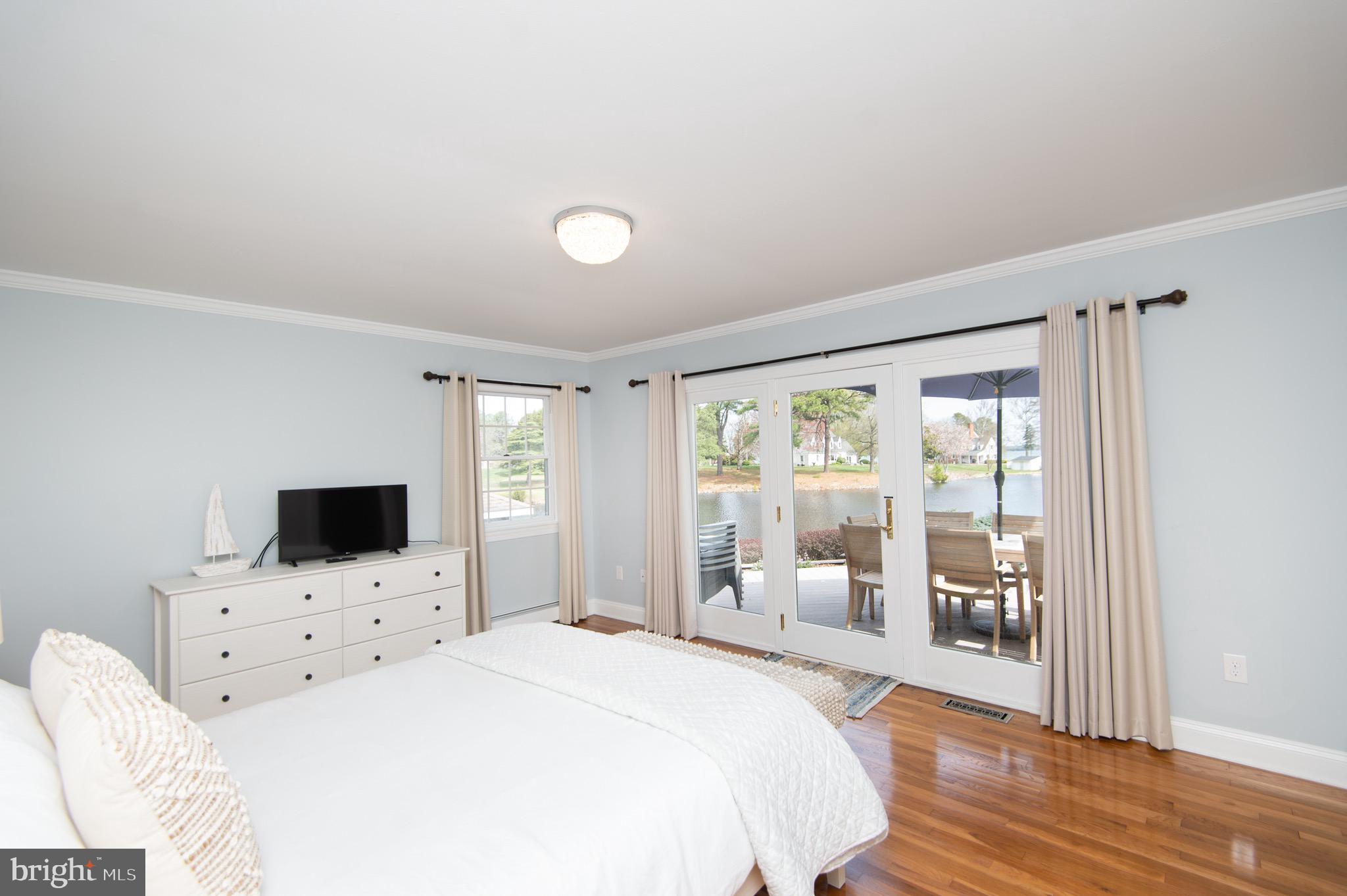 1417 School Street Cambridge, MD 21613 - Photo 35 of 73 a bedroom with a bed and a flat screen tv