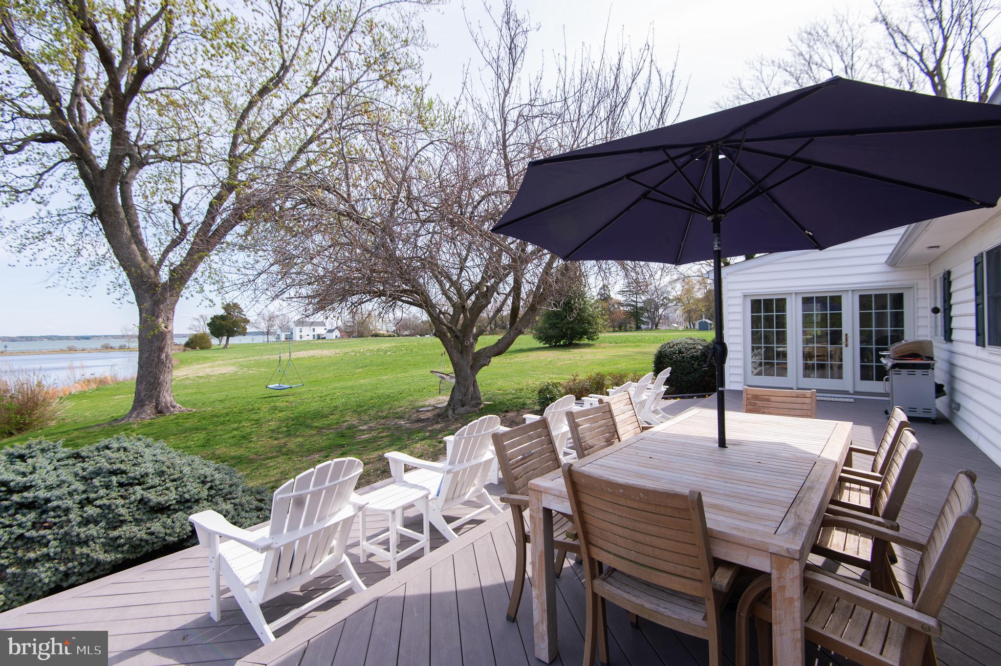 1417 School Street Cambridge, MD 21613 - Photo 57 of 73 a view of patio with table and chairs under an umbrella