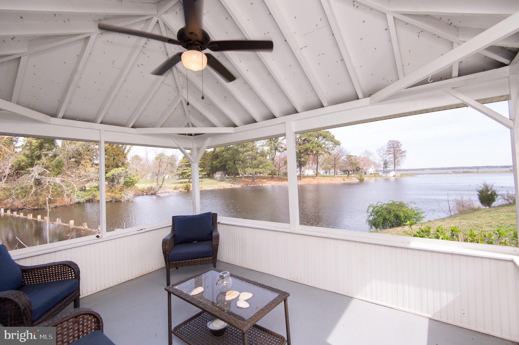 1417 School Street Cambridge, MD 21613 - Photo 62 of 73 a living room with furniture and a floor to ceiling window