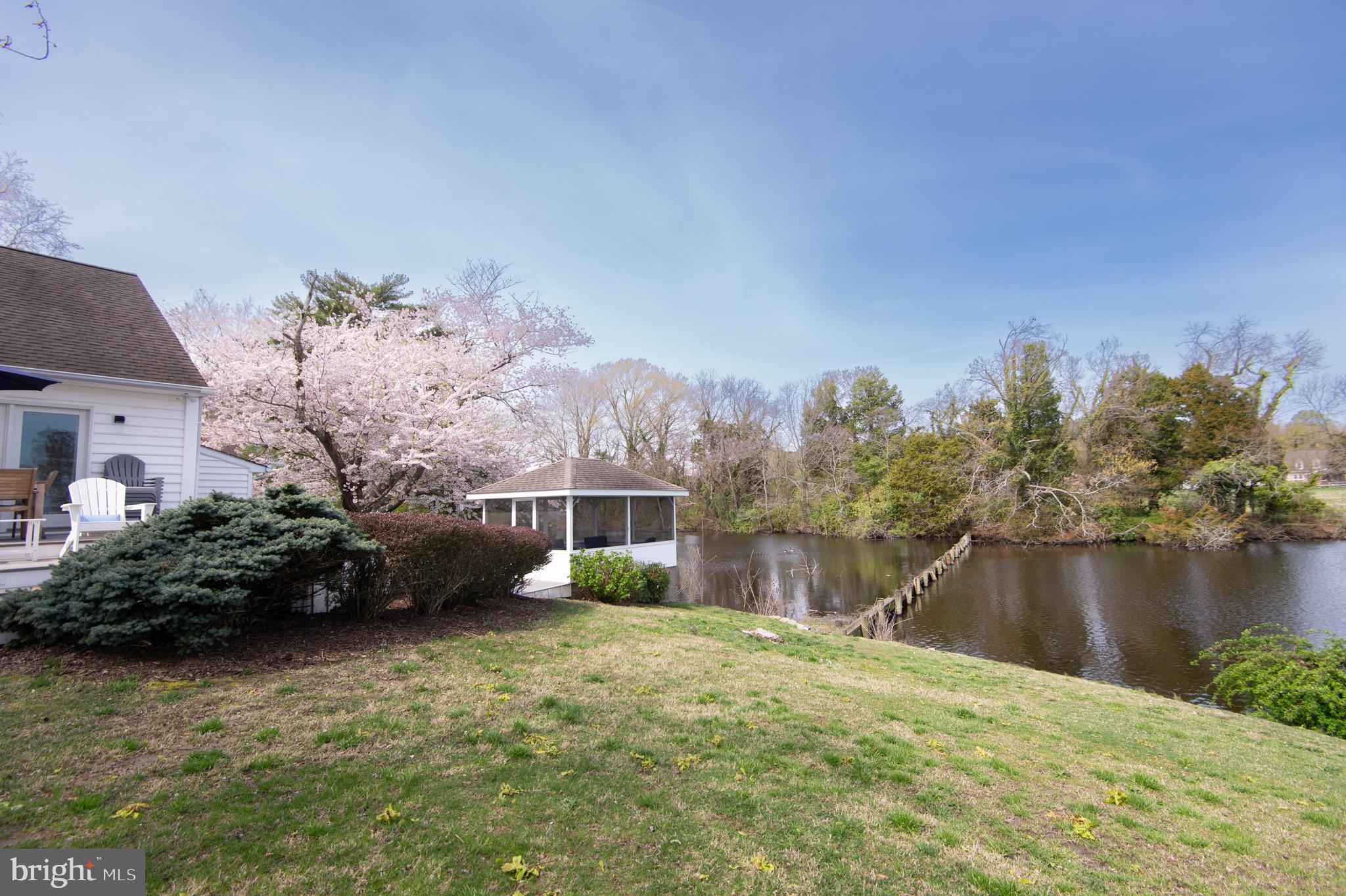 1417 School Street Cambridge, MD 21613 - Photo 65 of 73 a backyard of a house with lots of green space and lake view