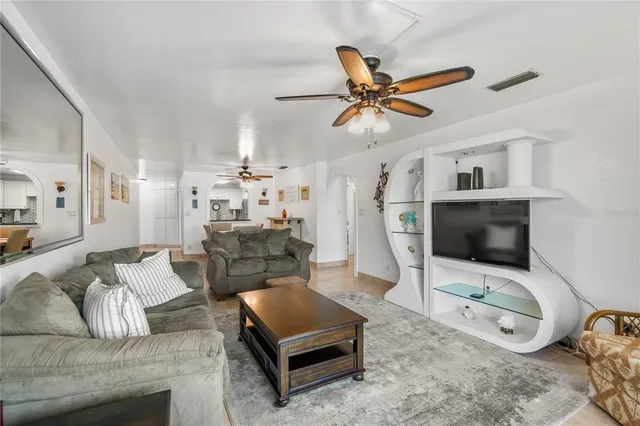 a bathroom with a granite countertop bathtub shower sink vanity and toilet
