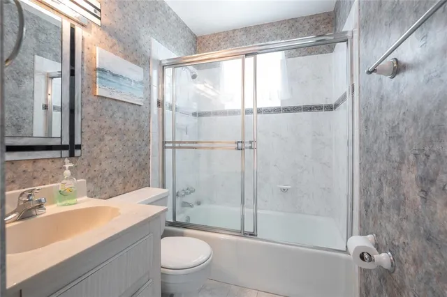 a bedroom with a bed mirror and window