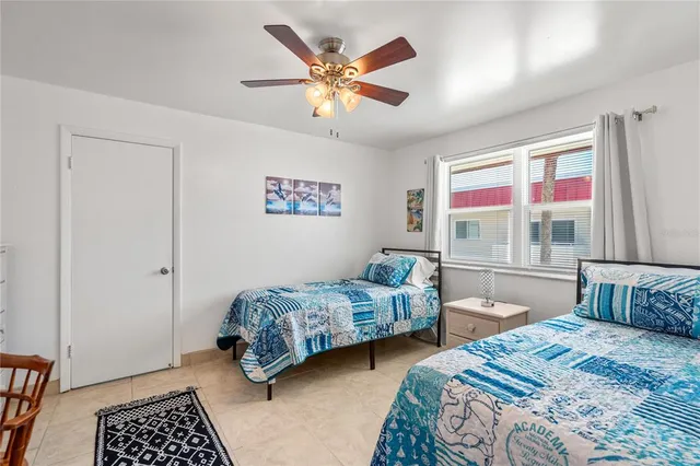 a bedroom with two beds and a window