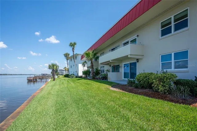 a view of a lake with boats and a large mountain view