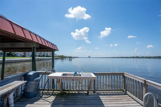 a view of roof deck with two chair and a floor to ceiling window