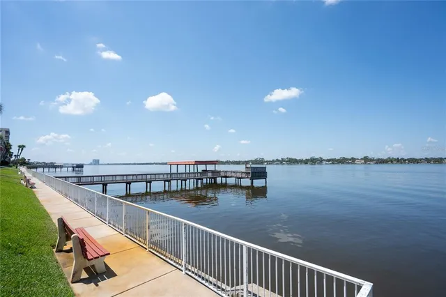a view of a balcony with wooden floor and iron stairs