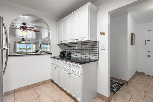 a kitchen with stainless steel appliances granite countertop a refrigerator sink and stove