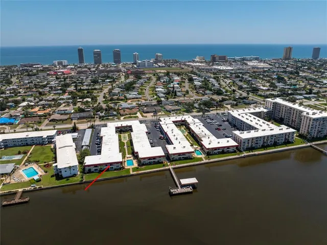 an aerial view of residential houses with city view