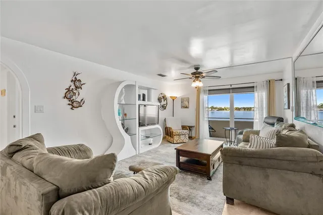 a view of a dining room with furniture and a chandelier fan