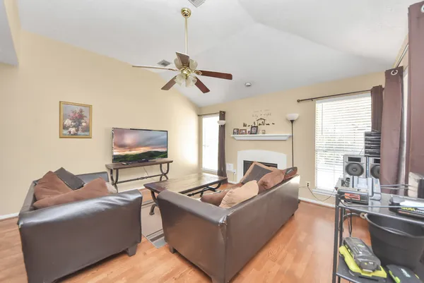 a living room with furniture a fireplace and a flat screen tv