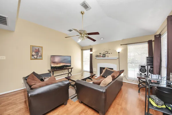 a living room with furniture floor to ceiling window and a flat screen tv
