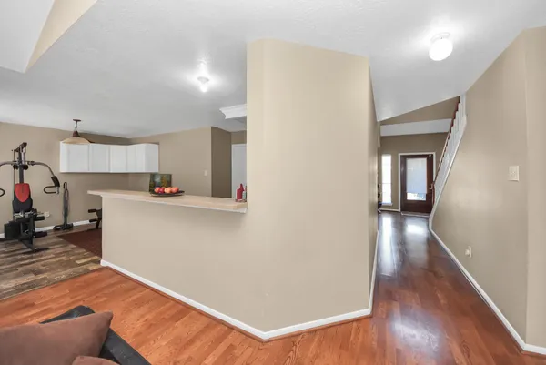 a view of a kitchen with wooden floor and a refrigerator