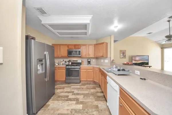 a kitchen with stainless steel appliances a refrigerator sink and cabinets