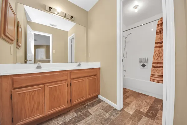 a spacious bathroom with a shower sink and mirror