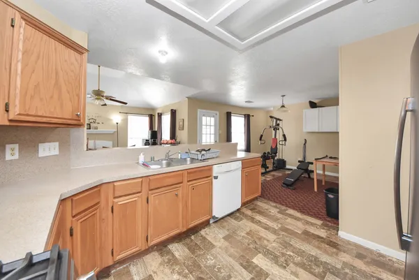 a large white kitchen with a sink and cabinets