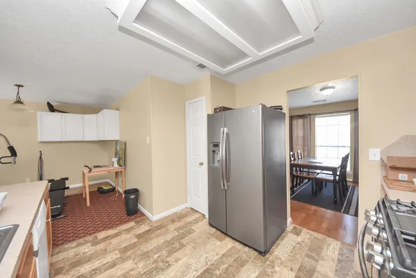 a kitchen with a refrigerator and a stove top oven