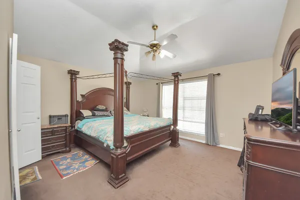 a bedroom with a bed and a chandelier