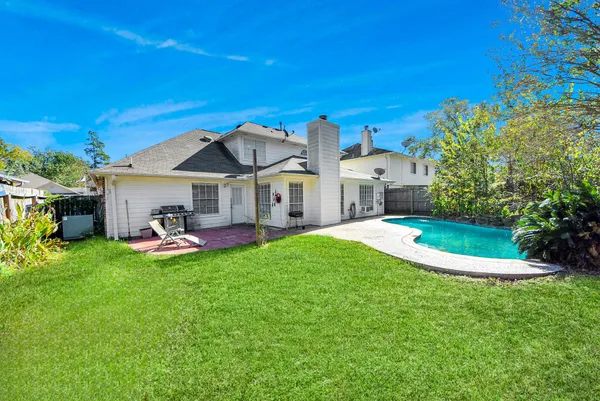 a view of a house with backyard porch and sitting area