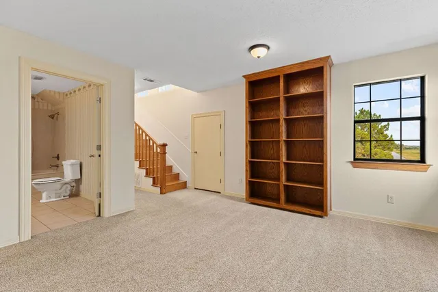 a view of empty room with closet and wooden floor