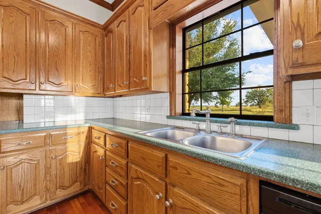a kitchen with granite countertop a sink and a window