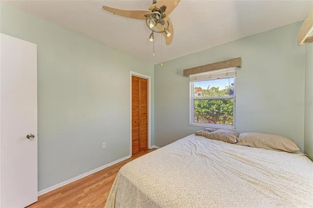 a bedroom with a bed and a window