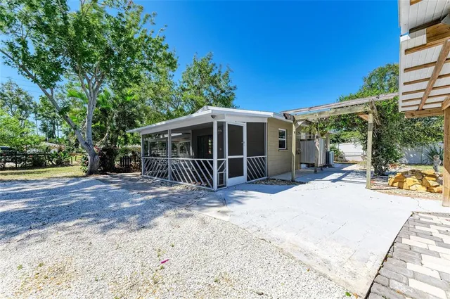 a view of a house with backyard and sitting area