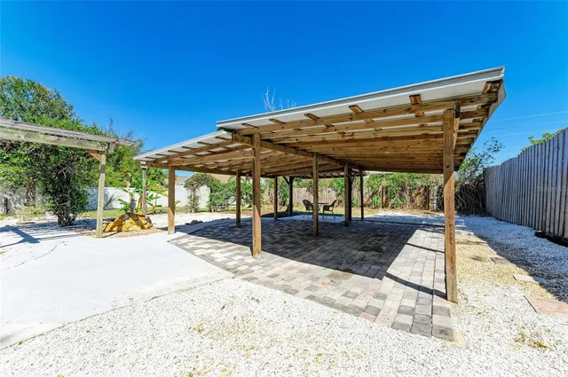 a view of patio with swimming pool table and chairs