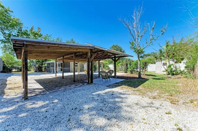 a view of a patio with a table and chairs under an umbrella