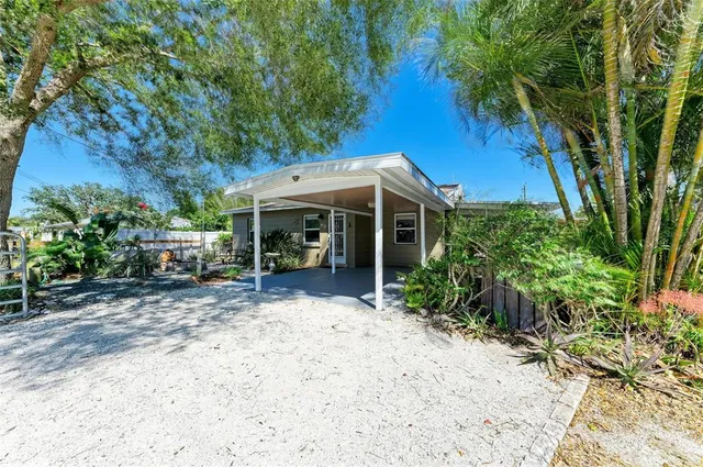 a view of a house with garden and sitting area