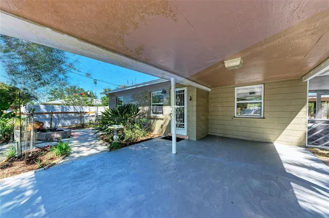 a view of a house with porch and garden