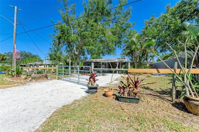 a view of a house with backyard porch and sitting area