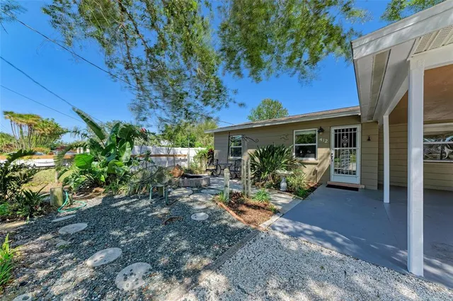 a view of a house with backyard porch and sitting area
