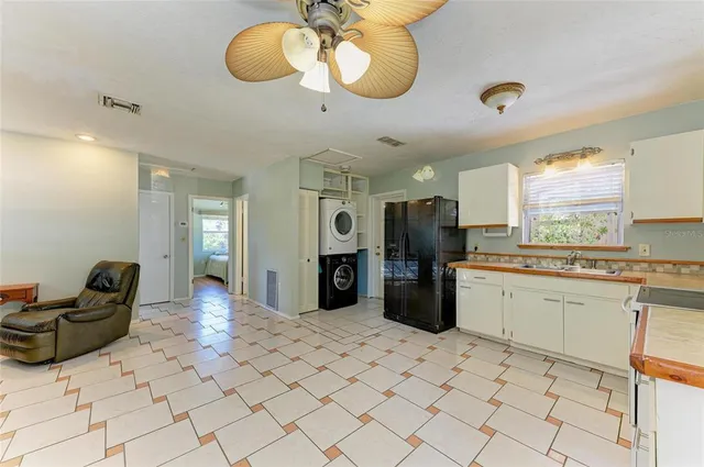 a large kitchen with stainless steel appliances kitchen island granite countertop a sink and cabinets