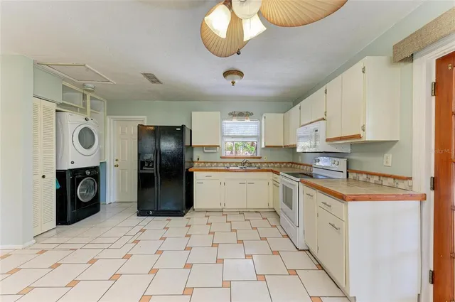 a kitchen with a sink a stove and cabinets