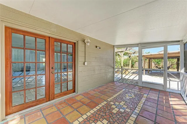 a bedroom with a bed and glass door