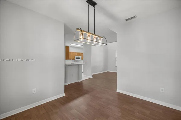 a view of a kitchen with wooden floor and a sink