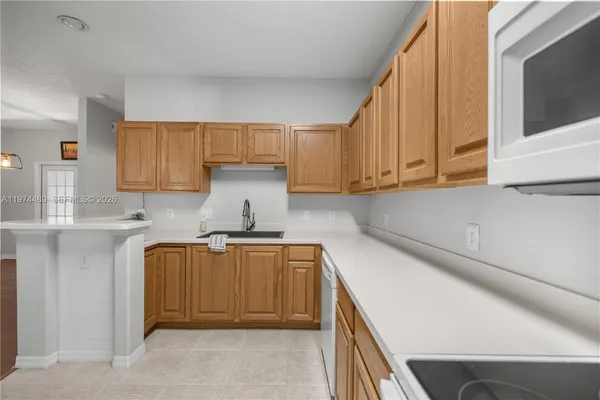 a kitchen with a sink a stove and cabinets