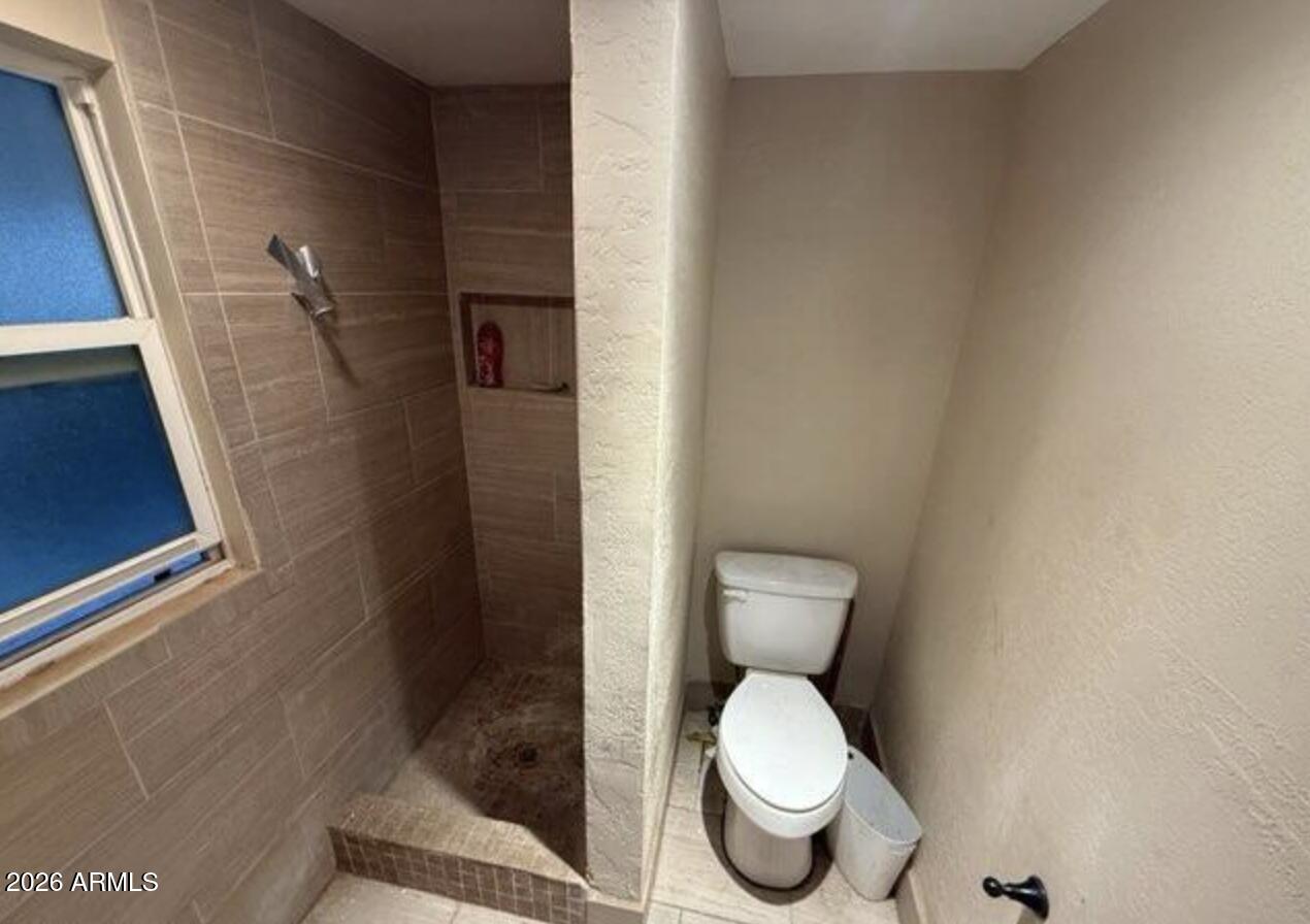 252 Debs Circle Morristown, AZ 85342 - Photo 4 of 8 a white toilet sitting next to a bathroom sink