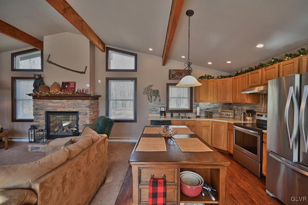 11 Hemlock Path Jim Thorpe, PA 18229 - Photo 11 of 36 a large kitchen with kitchen island a stove a sink a refrigerator wooden floor and dining table