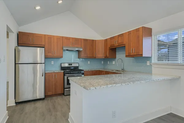 a kitchen with a refrigerator and a sink