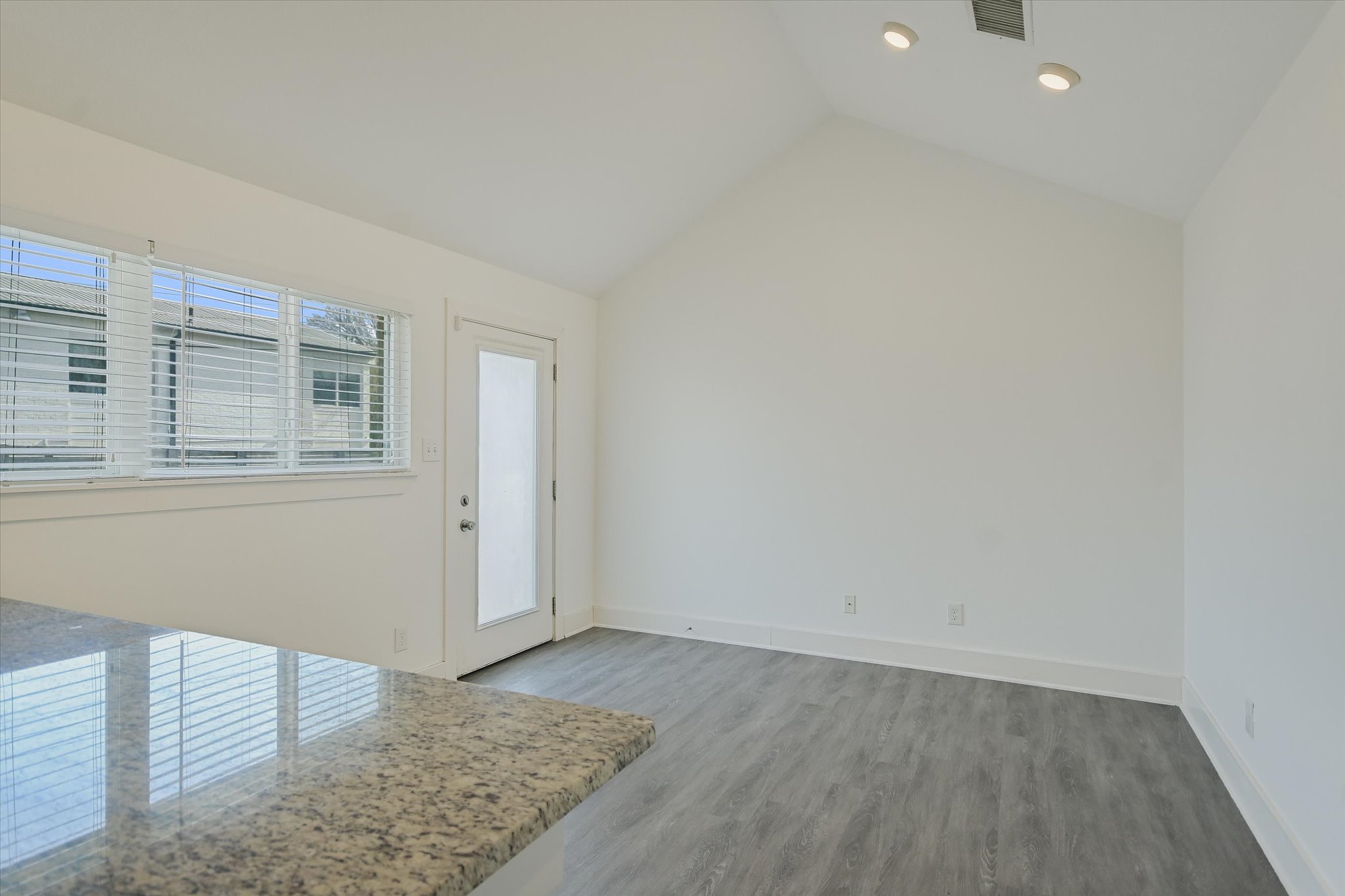 1311 East 52nd Street, Unit 2 Austin, TX 78723 - Photo 5 of 10 an empty room with wooden floor and window