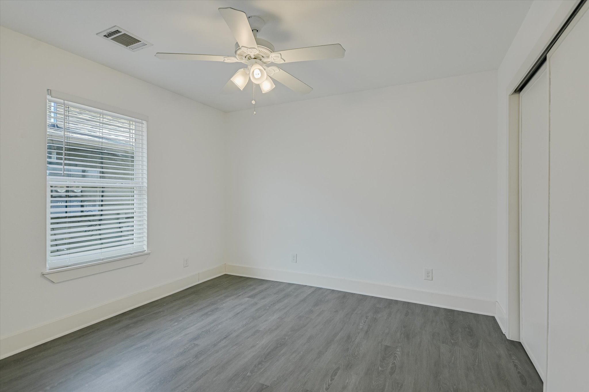 1311 East 52nd Street, Unit 2 Austin, TX 78723 - Photo 7 of 10 wooden floor in an empty room with a window