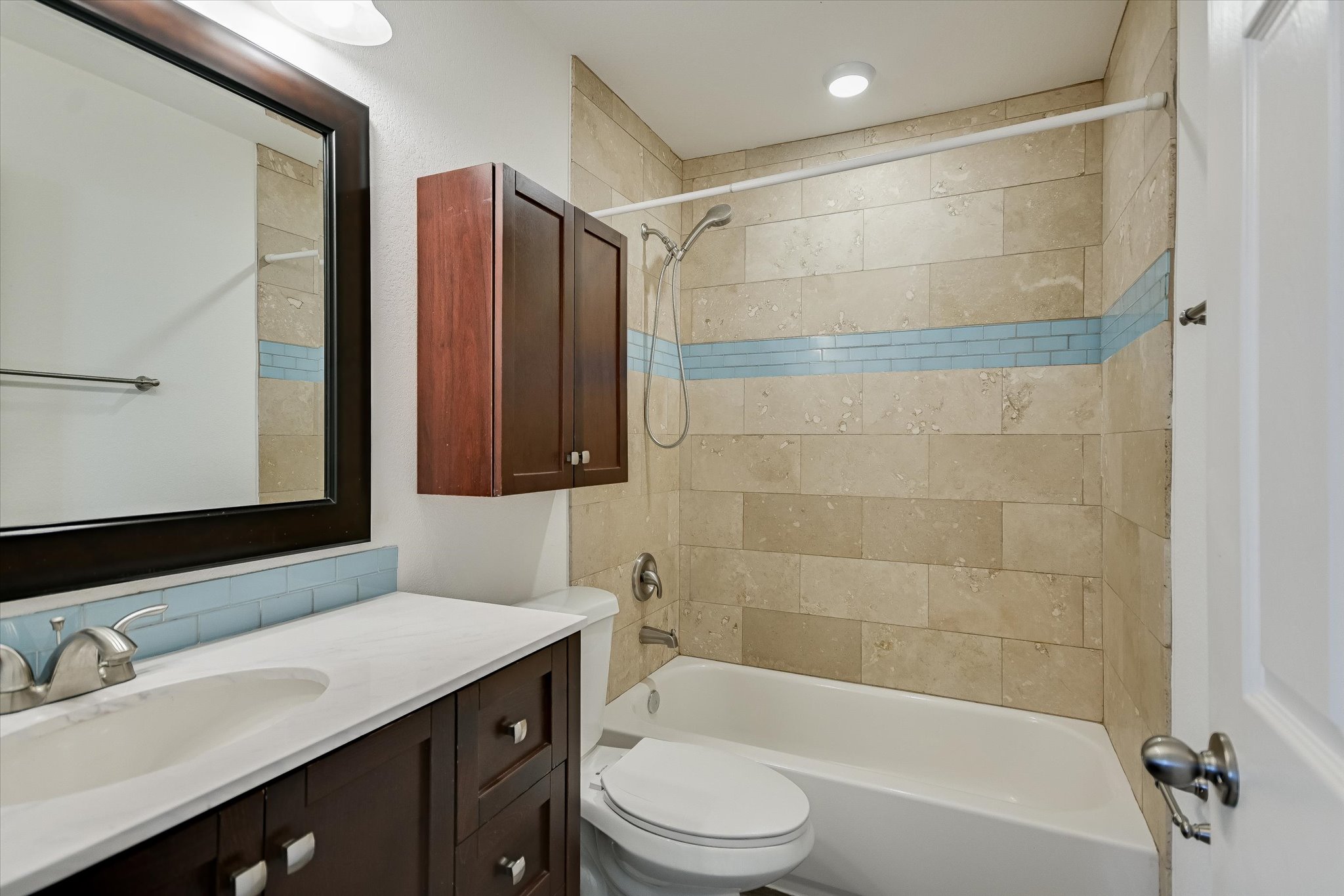 1311 East 52nd Street, Unit 2 Austin, TX 78723 - Photo 9 of 10 a bathroom with a sink a toilet and shower
