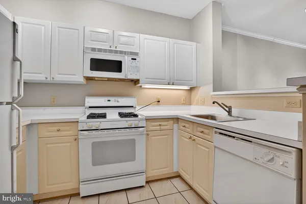 a kitchen with a stove top oven sink and cabinets