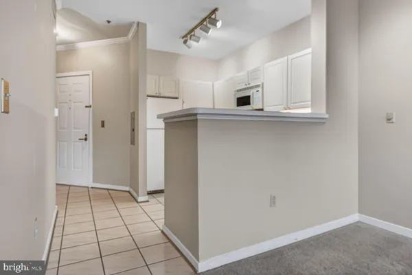 a kitchen with white cabinets and white appliances