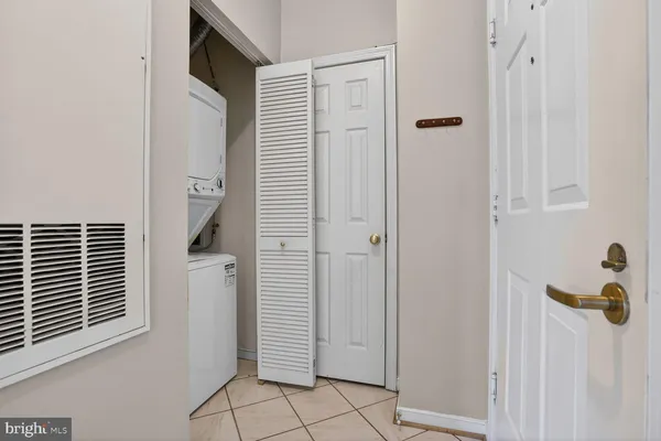 a view of a refrigerator in kitchen and white cabinets