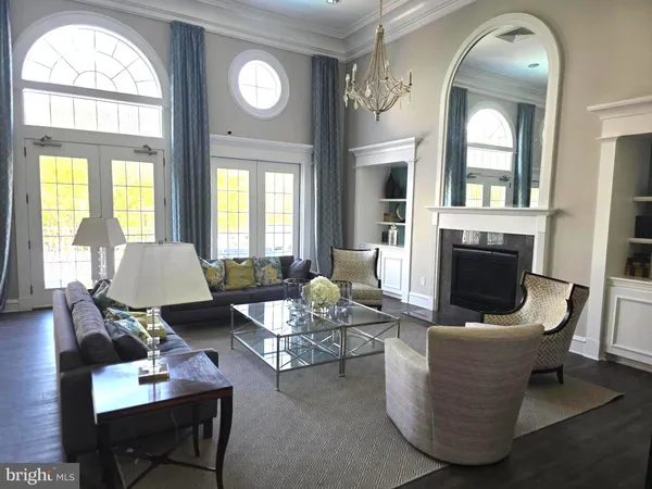 a living room with furniture a fireplace and a large mirror